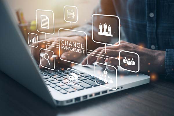 Laptop with overlay icons representing change management concepts.