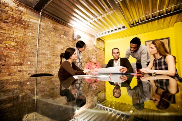 Five people working together at a table