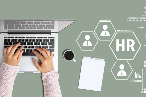 Hands on laptop with shapes representing HR