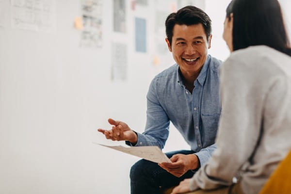 A man reviews a resume with a job seeker.