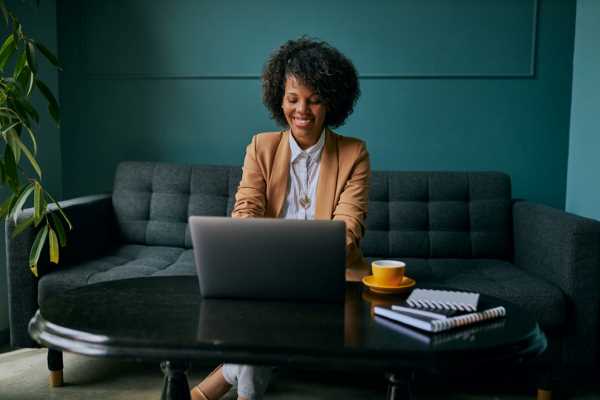 A woman sits in front of a laptop during a virtual interview.