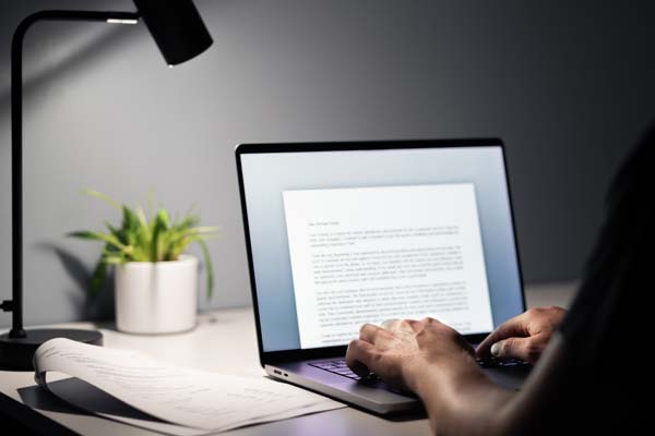 A person typing on a laptop.