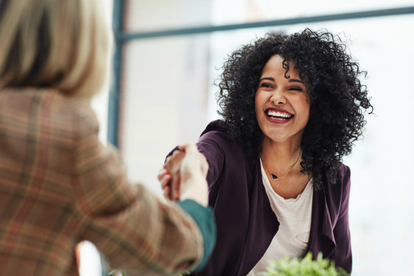 Woman on a job interview shaking hands with interviewer