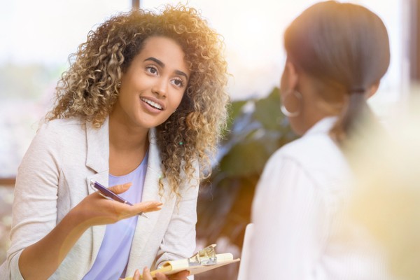 A rehabilitation counselor helps a young woman work through her concerns.