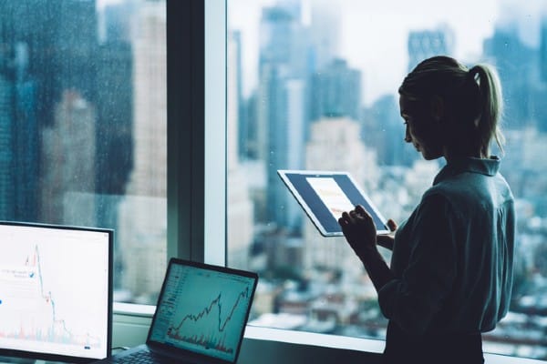 An office worker uses her tablet to work.