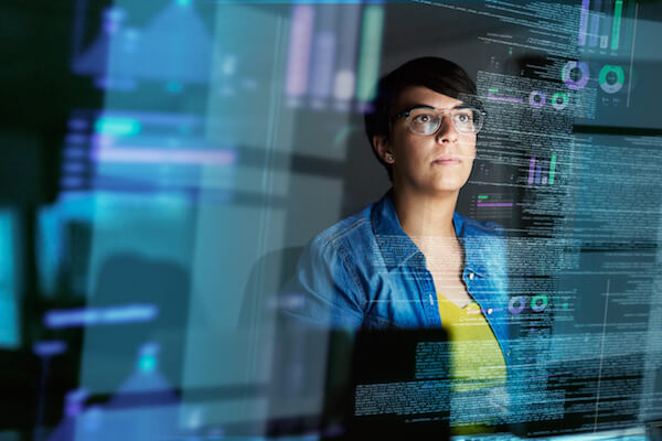 A woman reviews computer code.