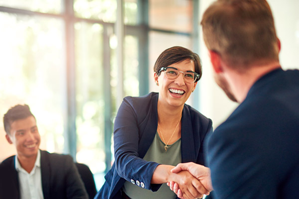 Two people shake hands