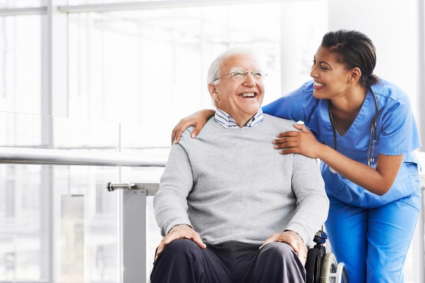 A nurse cares for her older patient.