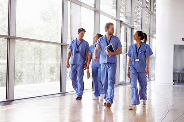 A group of nurses walking in a hospital