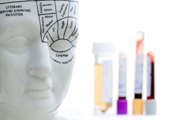 A mannequin head with different emotions written on the face.