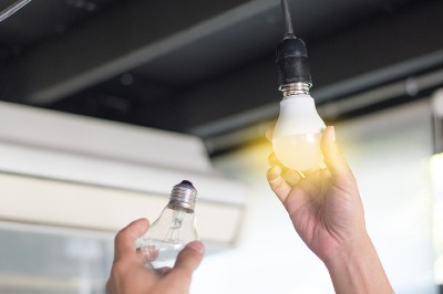 A person changes a light bulb
