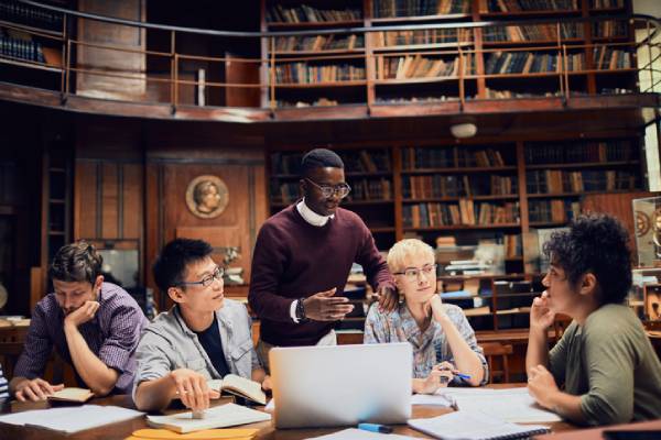 A university professor speaks to a diverse group of students