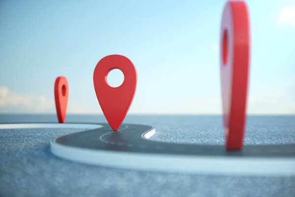 Three red pin markers on a road, depicting goal setting