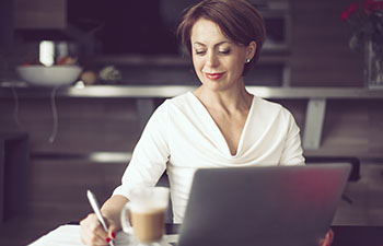 Women in office looking at laptop