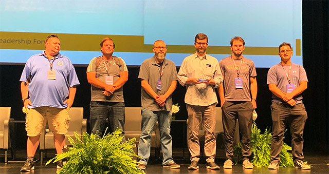 Purdue Global students Andre Coronado, Jacob Mack, Michael Staats, Nicholas Huser, and Wyn Forsterat holding the Hack the Port 2022 Executive Leadership Forum Silver Medal trophy